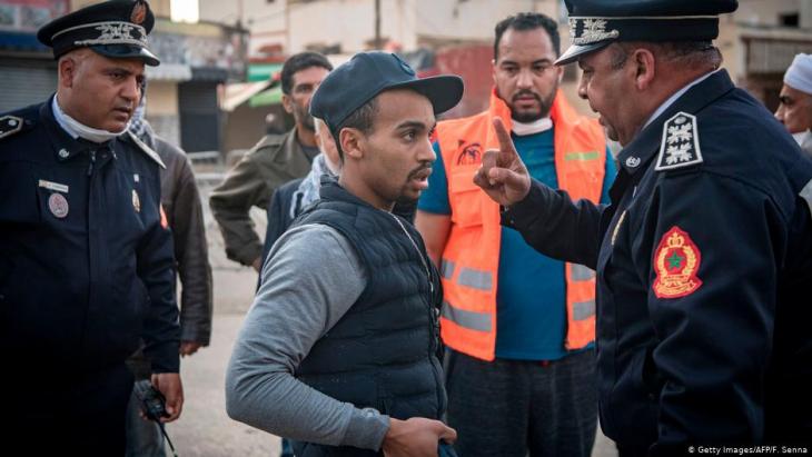 Moroccan police in Rabat instructing a resident in the capital to return home on 27 March 2020 (photo: Getty Images/AFP)