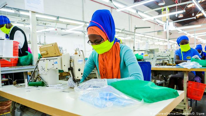 An employee at Shona EPZ Limited sewing face masks (photo: SOPA Images/D. Sigwe)