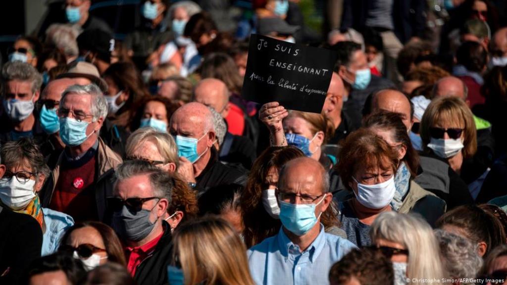 People wearing COVID-19 face masks at the funeral service for murdered teacher Samuel Paty in Paris (photo: Christophe Simon/AFP/Getty Images)