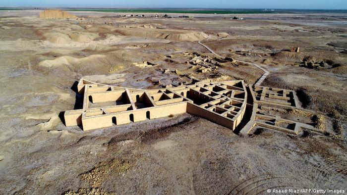 Archaeological site, walls of buildings, seen from above, arid land surrounds it