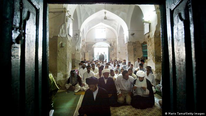Muslims in Iraq pray in a mosque