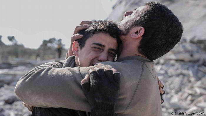 A photo by the Syrian photographer Ghaith Alsayed shows two brothers mourning