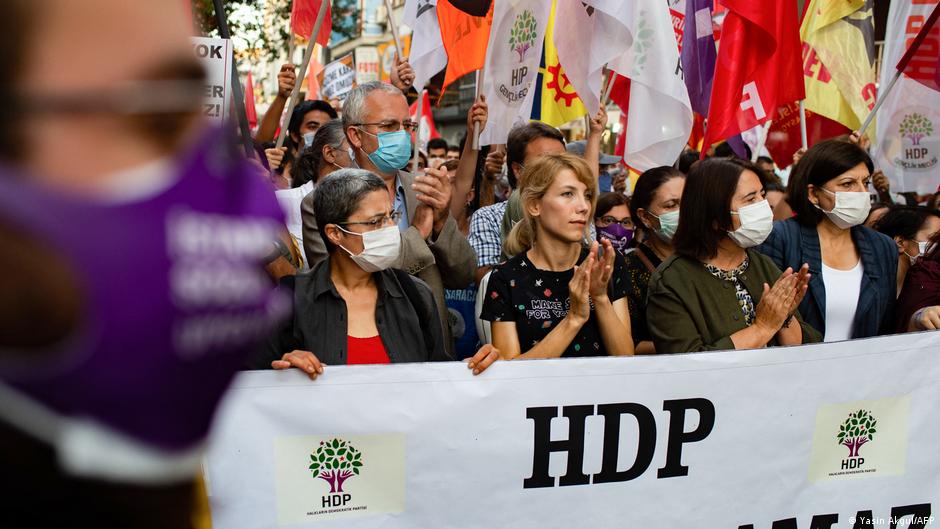 Protesters holding a HDP banner and flags during a march in Istanbul (photo: Yasin Akgul/AFP)