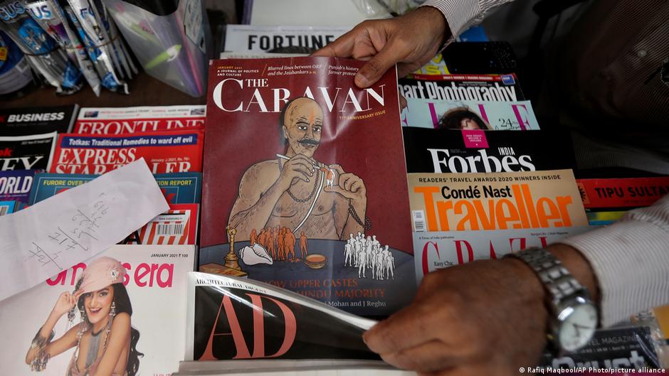 A vendor reaches out for a copy of The Caravan, India’s leading investigative magazine, in Mumbai, India, 5 February 2021 (photo: AP Photo/Rafiq Maqbool)