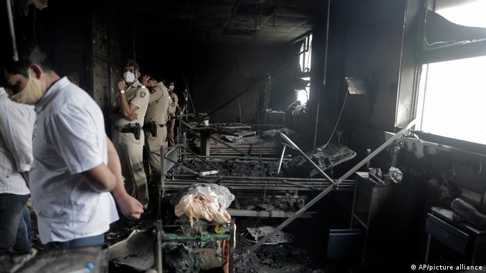 People inspect an ICU ward after a fire broke out in Vijay Vallabh COVID-10 hospital at Virar, near Mumbai