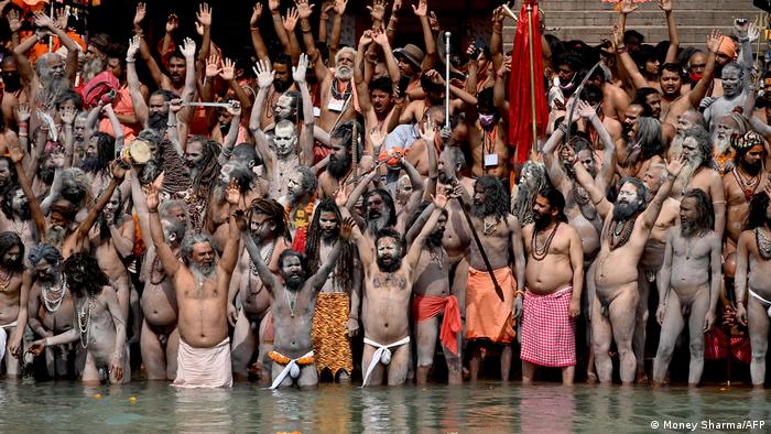 Naga Sadhus (Hindu holy men) take a dip in the waters of the Ganges river on the day of Shahi Snan (royal bath) during the ongoing religious Kumbh Mela festival, in Haridwar on 12 April 2021