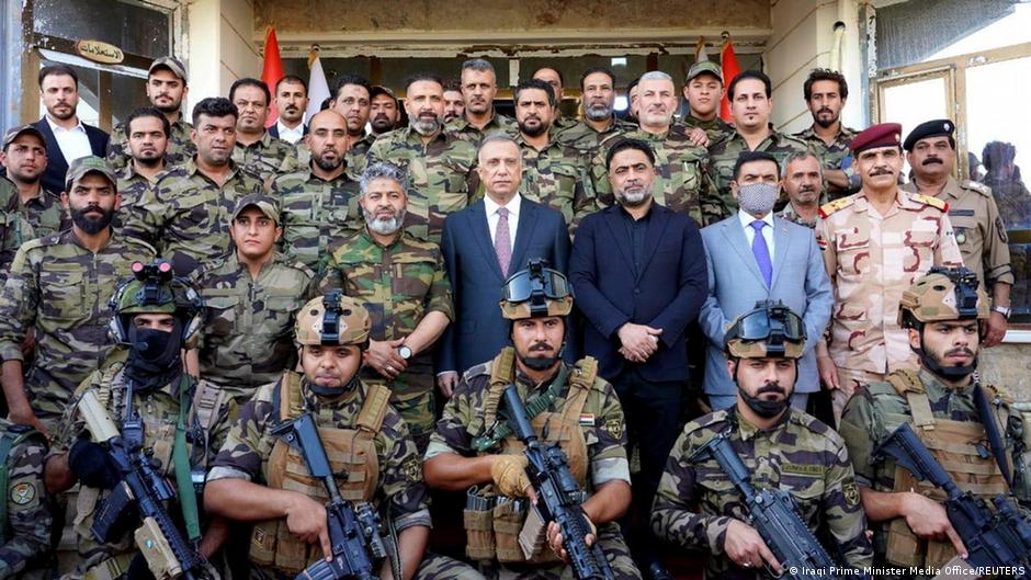 Iraqi Prime Minister Mustafa al-Kadhimi poses for a group photo with Shia fighters from Saraya al-Salam, who are loyal to cleric Muqtada al-Sadr, in Samara, Iraq, 16 June 2021 (photo: Iraqi Prime Minister Media Office/Reuters)