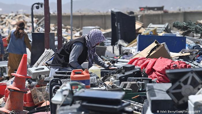 A man searches U.S. Army electronic waste in Bagram