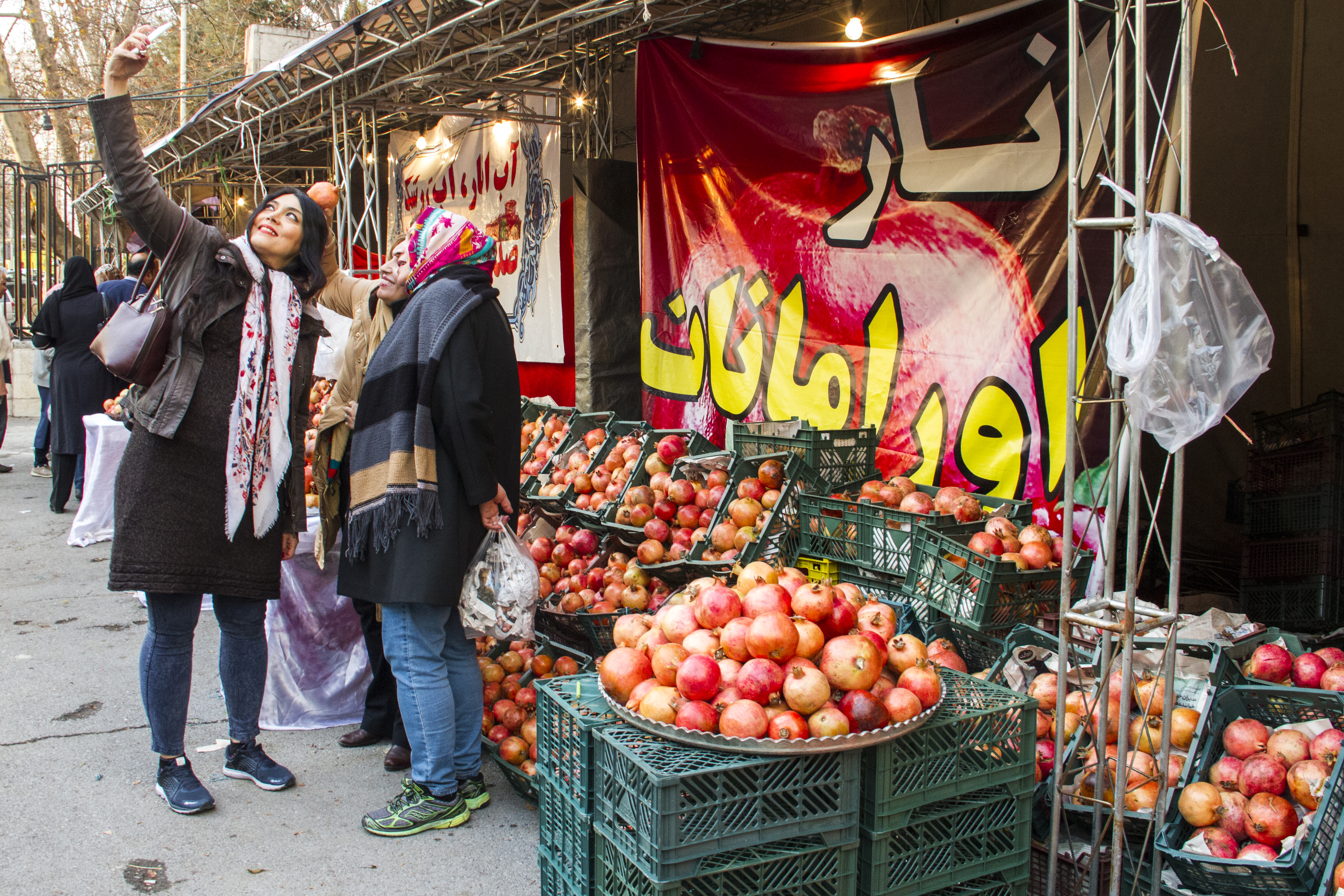 A group of women take a selfie in a pomegranate market before Yalda (photo: Changiz M. Varzi)