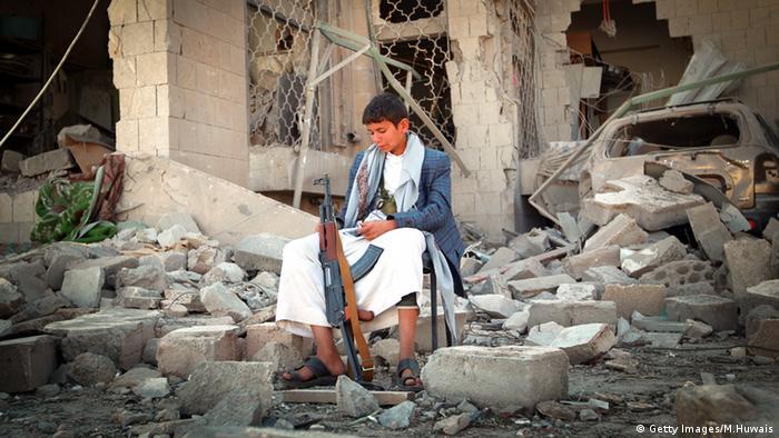 A child Houthi soldier sits among the rubble of a house in the Yemeni capital, Sanaa (photo: Getty Images/M. Huwais)