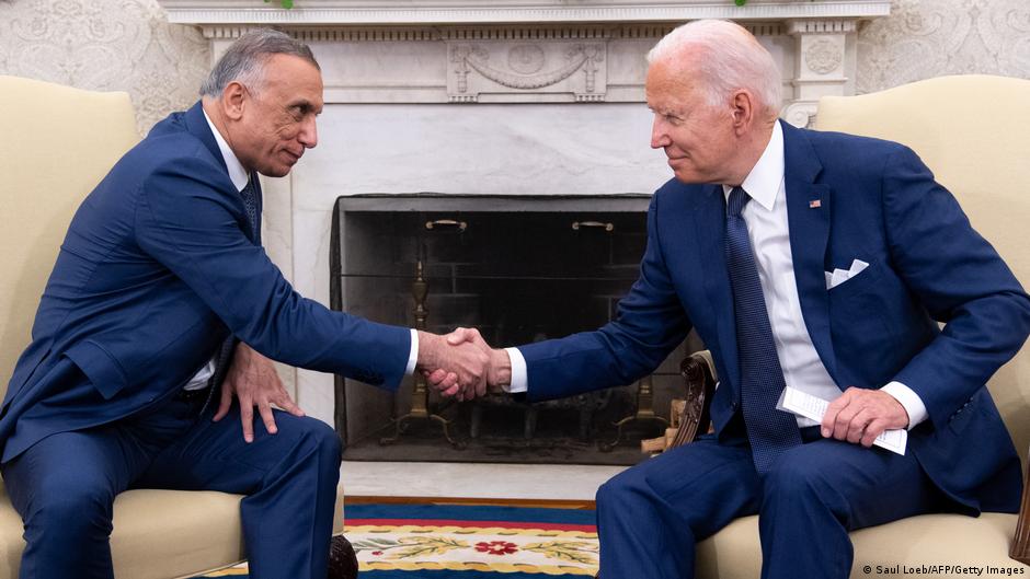 Mustafa al-Kadhimi (left) Joe Biden shaking hands in Washington, 26 July 2021 (photo: Saul Loeb/AFP/Getty Images)
