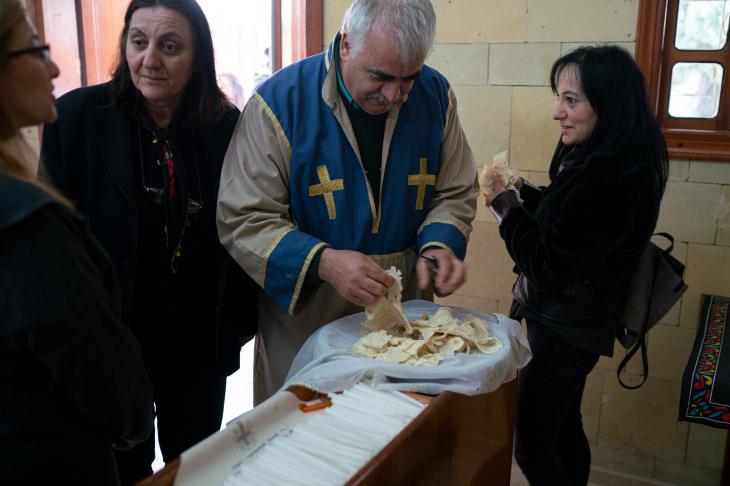 Priest and members of the congregation share traditional lavash bread after the Church service in the village of Vakıflı (photo: Jochen Menzel/transfers-film)