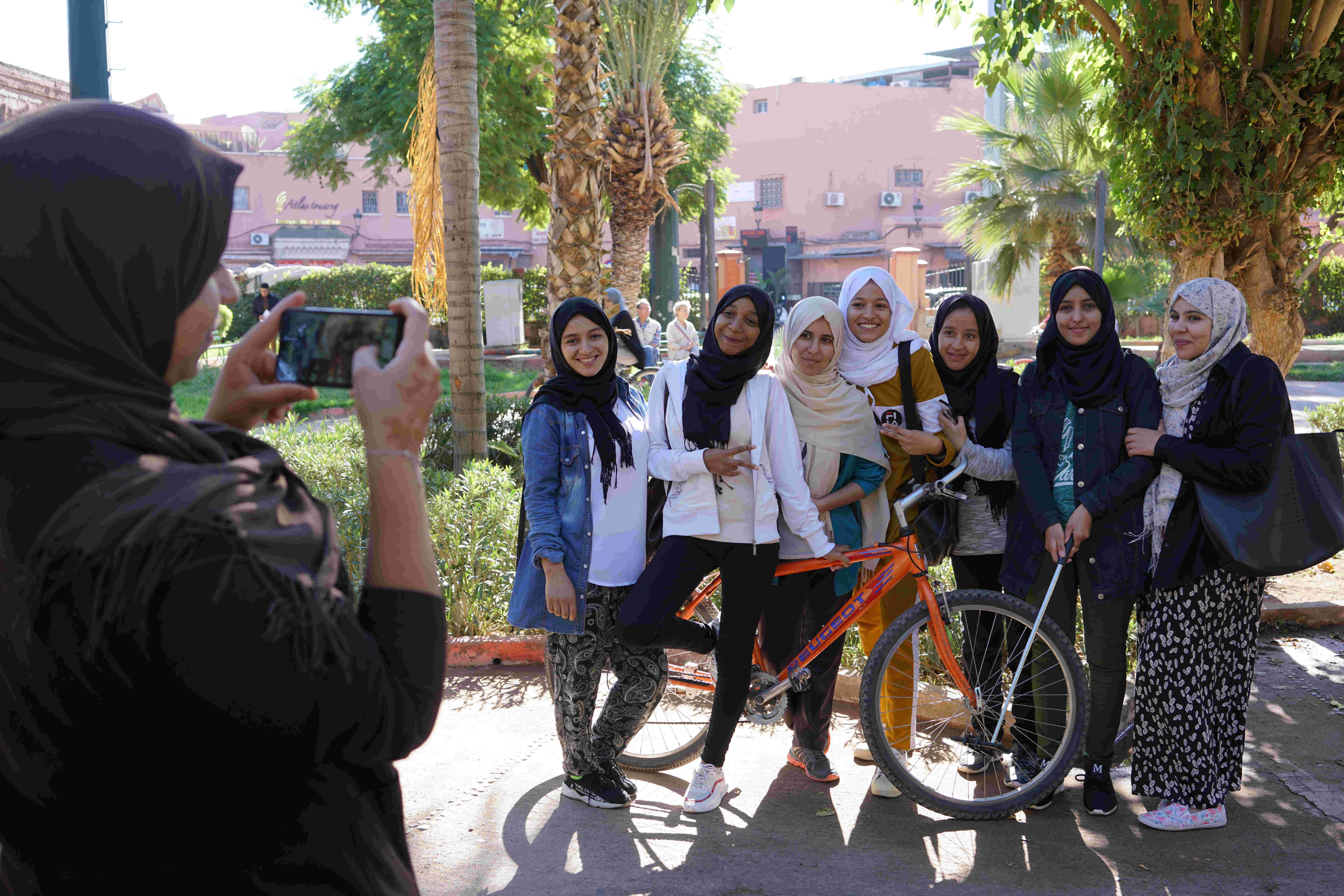 Young women pose for photos with a bicycle, Pikala Bikes, Marrakech, Morocco (photo: Marian Brehmer)