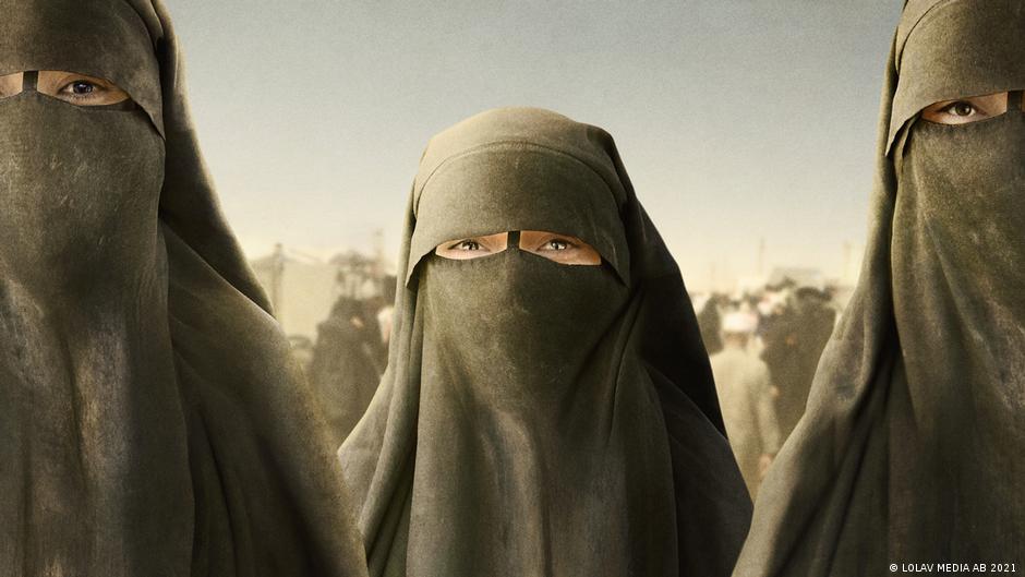 Still from "Sabaya": Three women wearing a niqab stare into the camera