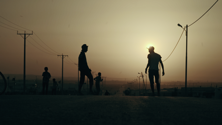 Still from "Captains of Zaatari": Two youths silhouetted against an evening sky