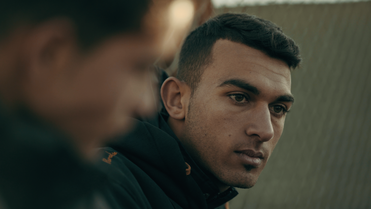 Still from "Captains of Zaatari": The faces of two youths, one looking toward the camera, one in profile