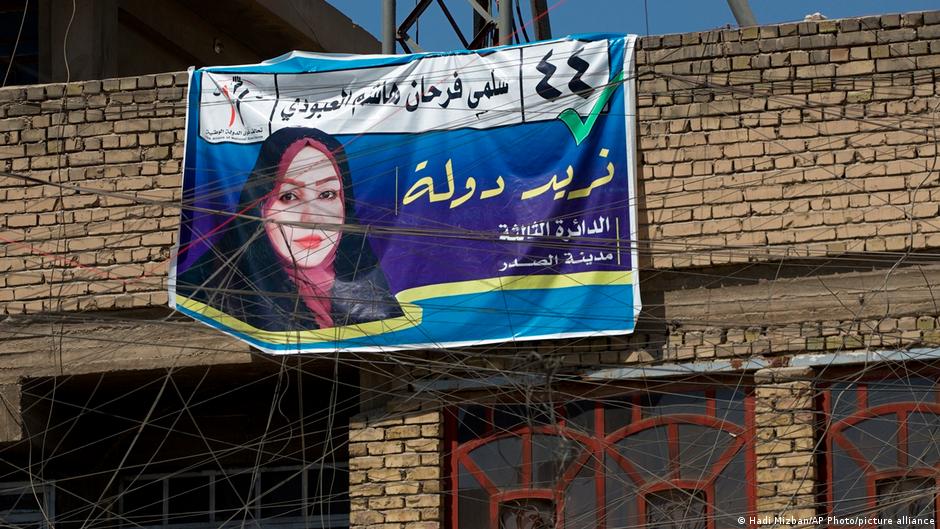 A campaign poster for upcoming early parliamentary elections is hanging behind a private generator network wires in Baghdad, Iraq, Monday, 20 September 2021 (photo: AP Photo/Hadi Mizban)