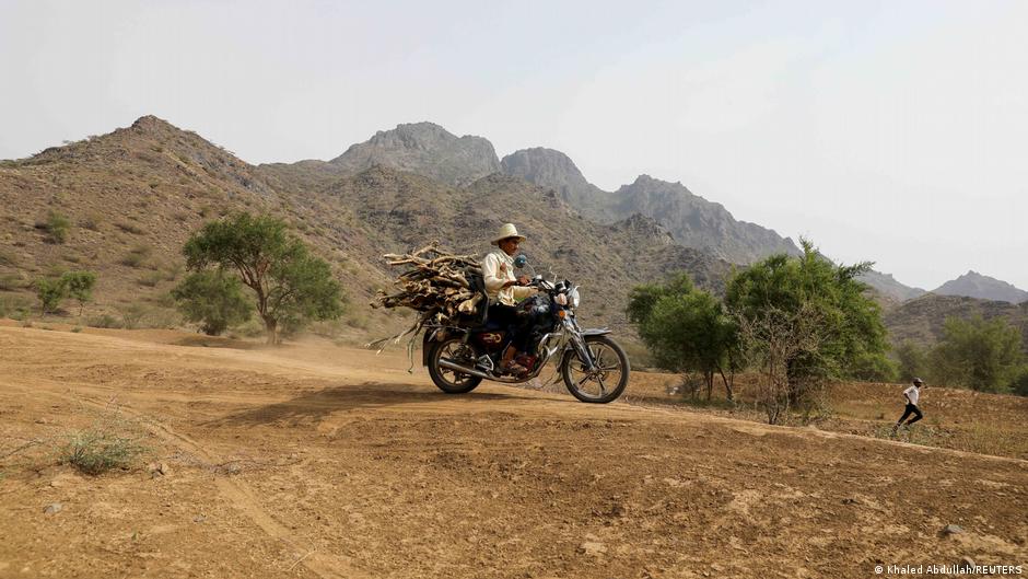 A lumberjack carries firewood bundles on a motorcycle in Bajil district of Hodeida province, Yemen, 24 June 2021 (photo: Reuters/Khaled Abdullah)