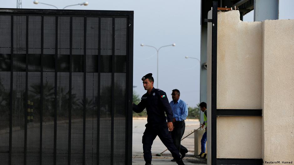 Jordanian policeman opens the border crossing gate between Jordan and Syria at Jabr (photo: Reuters/M. Hamed)