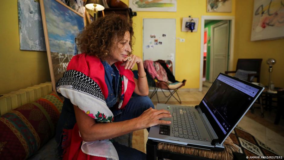 Palestinian cultural consultant and actress Huda al Imam watches her film "Ave Maria", which is part of the new "Palestinian Stories" collection launched on Netflix, at her home in the Sheikh Jarrah neighbourhood, Jerusalem, 14 October 2021.