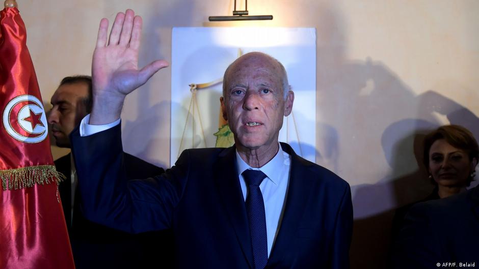Kais Saied raises his hand in celebration of his landslide victory in the 2019 presidential election (photo: AFP/F. Belaid)