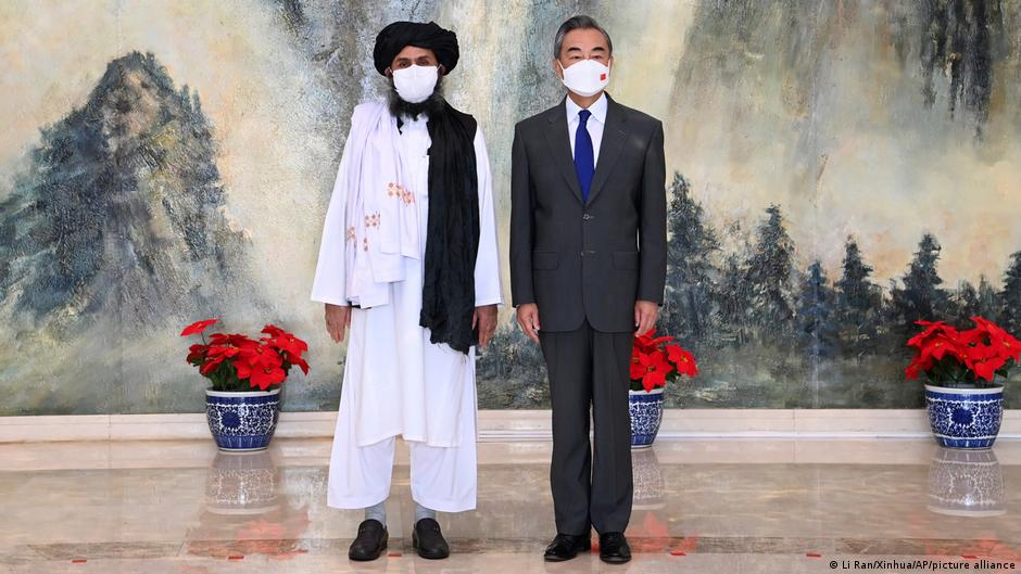 Taliban co-founder Mullah Abdul Ghani Baradar, left, and Chinese Foreign Minister Wang Yi pose for a photo during their meeting in Tianjin, China, 28 July 2021 (photo: Li Ran/Xinhua/AP)
