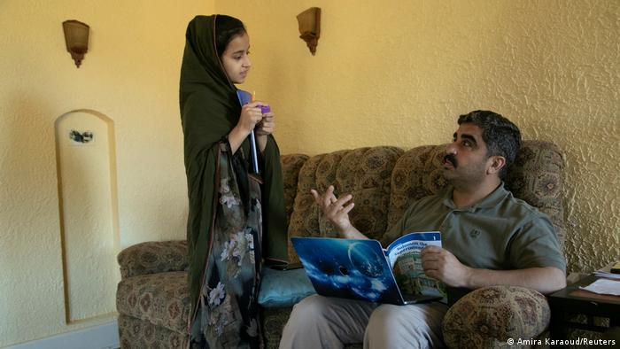 Wazir Khan Zadran, 41, helps his daughter Zuleikha Zadran, 15, with her homework in Bowling Green, Kentucky, USA
