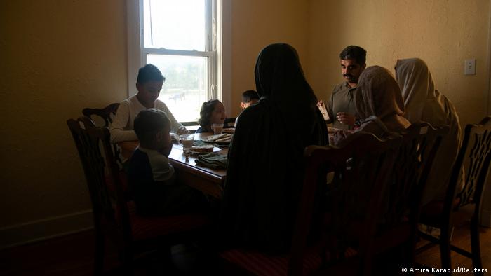 Wazir Khan Zadran, 41, and his wife, Noorina Zadran, 36, eat breakfast with their children