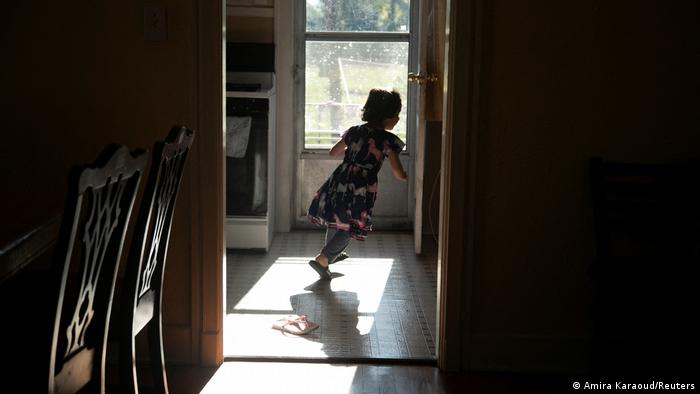One of the Zadran children runs away from the camera in the family home