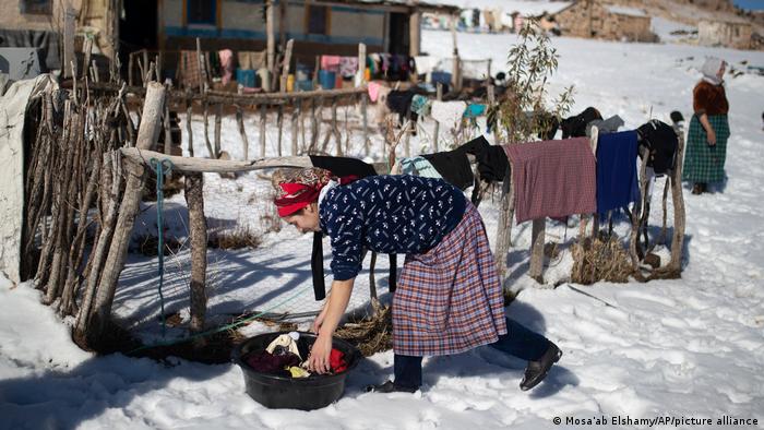 ثلوج حاصرت سكان قرية "تيمحضيت" المغربية 02 Eine Frau kümmert sich in verschneiter Landschaft um die Waesche im Bergdorf Timahdite in Marokko AP Photo Mosa'ab Elshamy