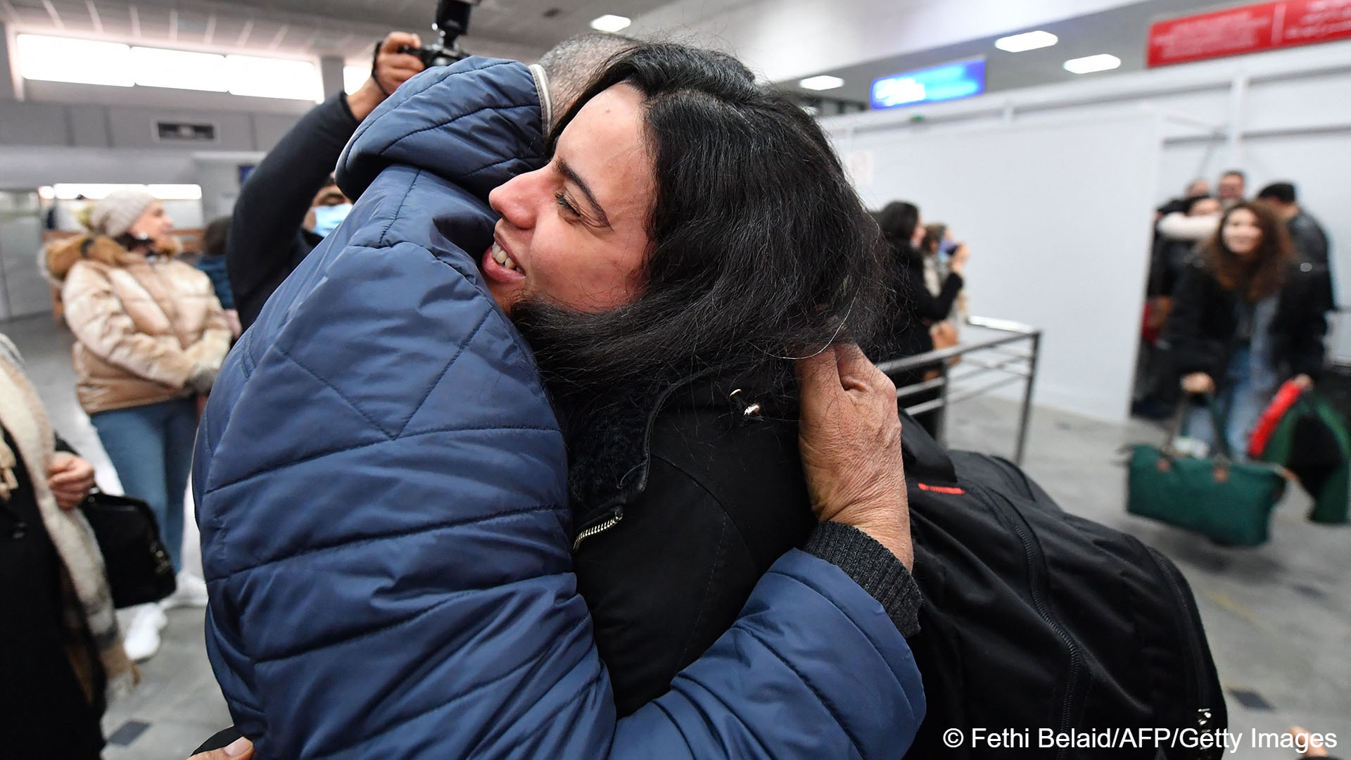 A student (R) evacuated from Ukraine is embraced by her relative upon her arrival at the Tunis-Carthage airport on 1 March 2022 (photo: FETHI BELAID / AFP)