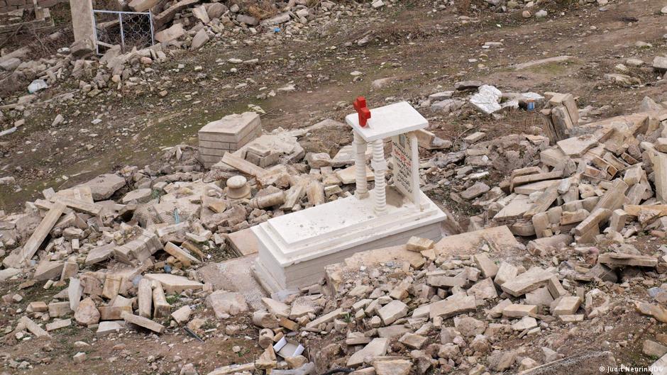 The cemetery is still in ruins, but this restored white grave has become a symbol of hope.