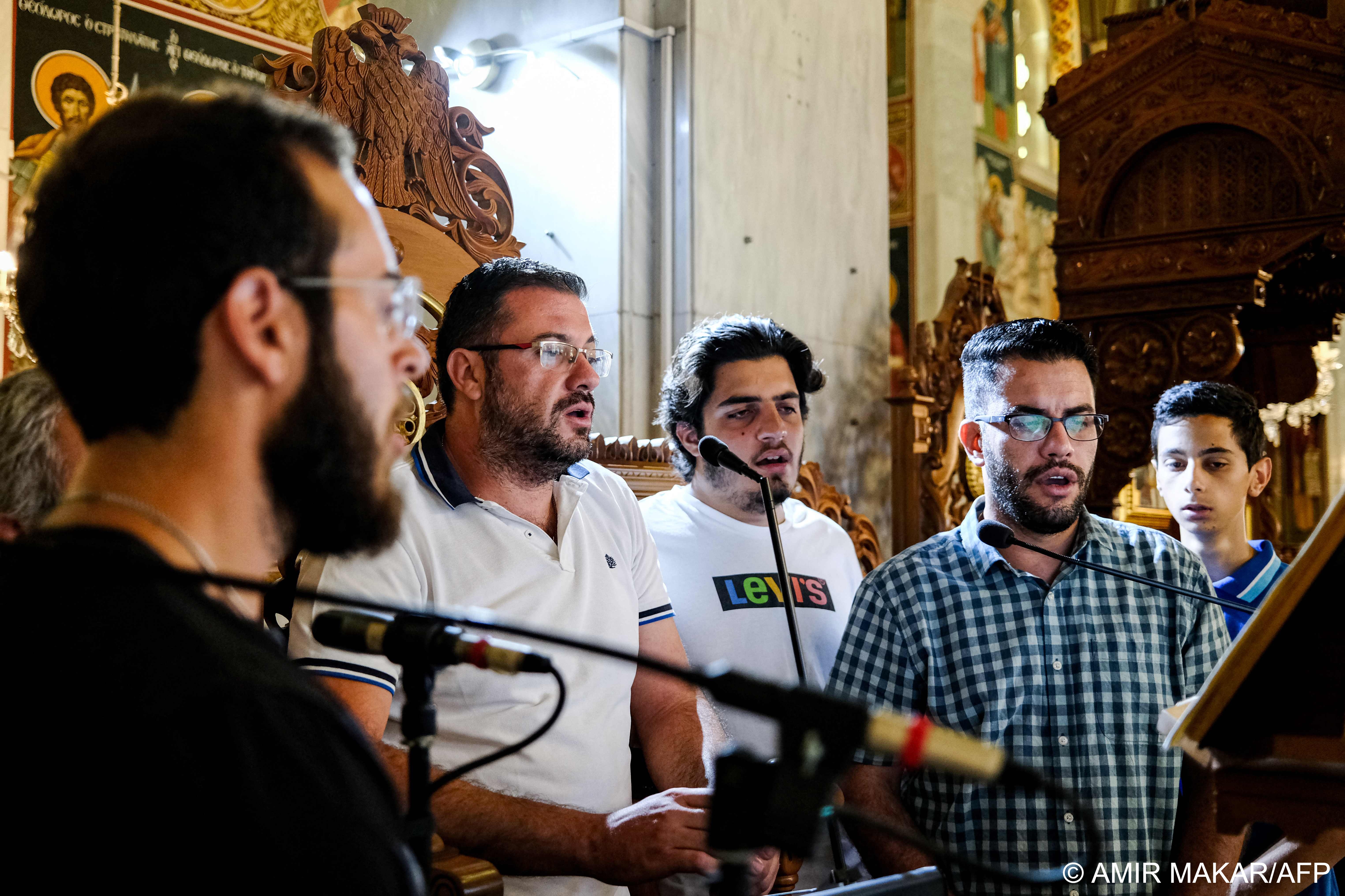 Evaggelos Georgiou (C) leads a group of volunteer chanters during mass at the the Greek Orthodox Church of Chryseleousa Panagia in the village of Athienou, Cyprus, on 8 August 2020 (photo: AFP)