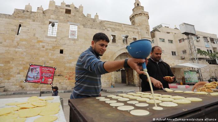 Men in Gaza make an Eid delicacy