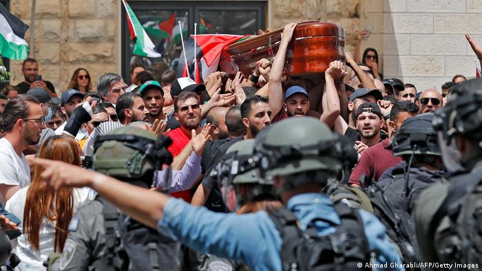 Israeli security forces face off Palestinian mourners carrying the casket of slain journalist Shireen Abu Akleh (photo: AFP/Getty Images)