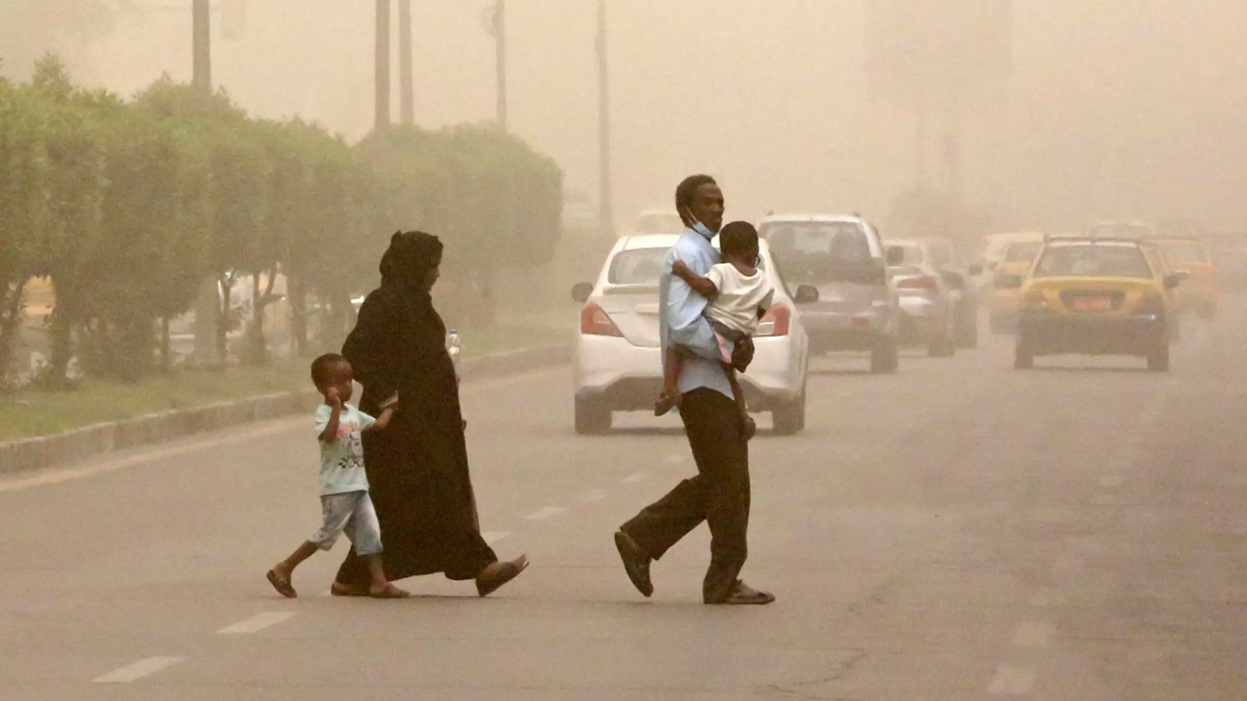 A family crosses a street during a sandstorm in the Iraqi capital Baghdad on 3 July: over the next two decades, Iraq can expect 272 dusty days per year, projected to surpass the 300-day mark by mid-century A family crosses a street during a sandstorm in the Iraqi capital Baghdad on July 3: over the next two decades, Iraq can expect 272 dusty days per year, projected to surpass the 300-day mark by mid-century (photo: Sabah ARAR/AFP)
