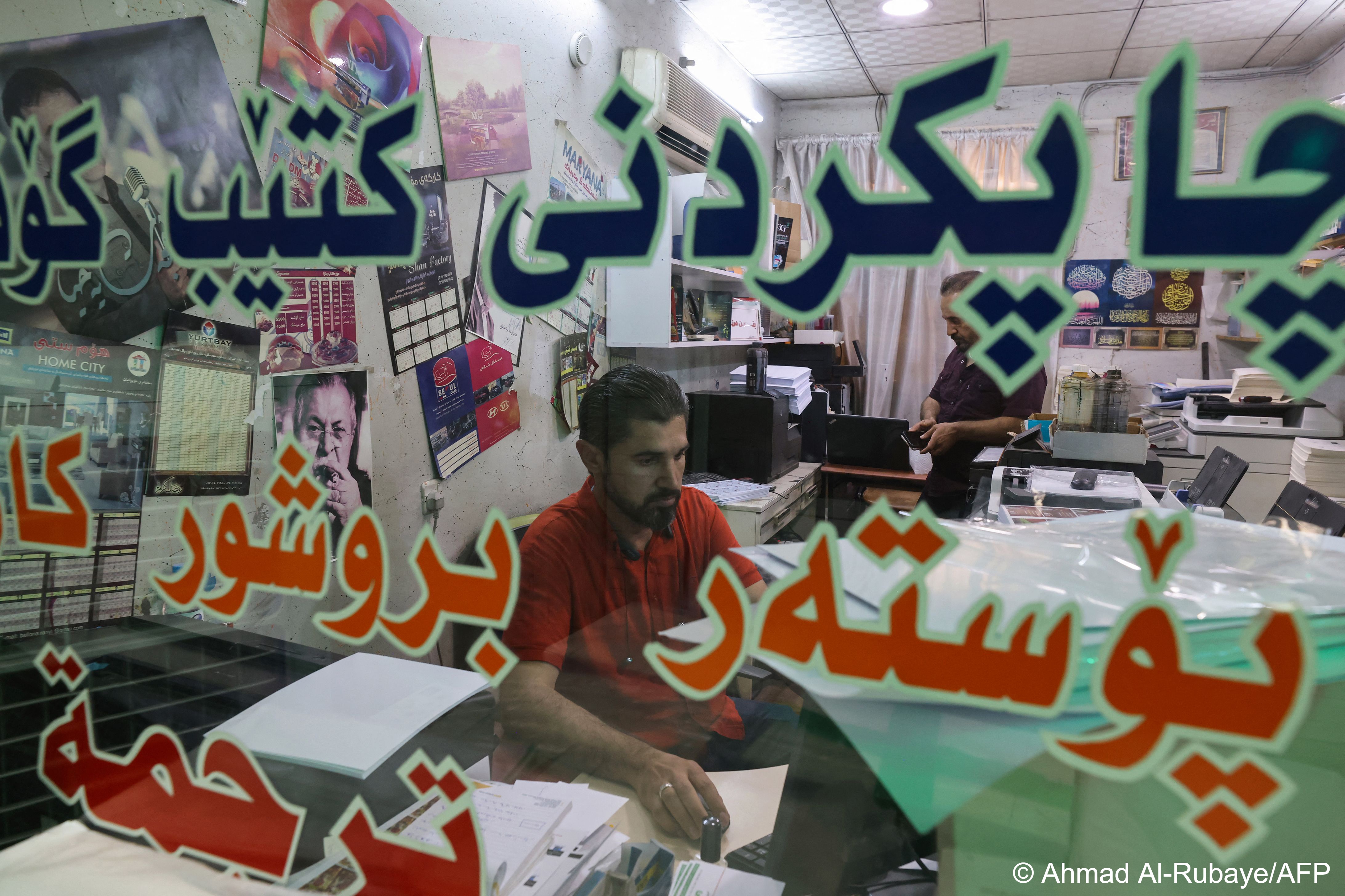 Talib works at his desk at a printing house in Iraq's northeastern city of Sulaimaniyah (photo: AHMAD AL-RUBAYE/AFP) 