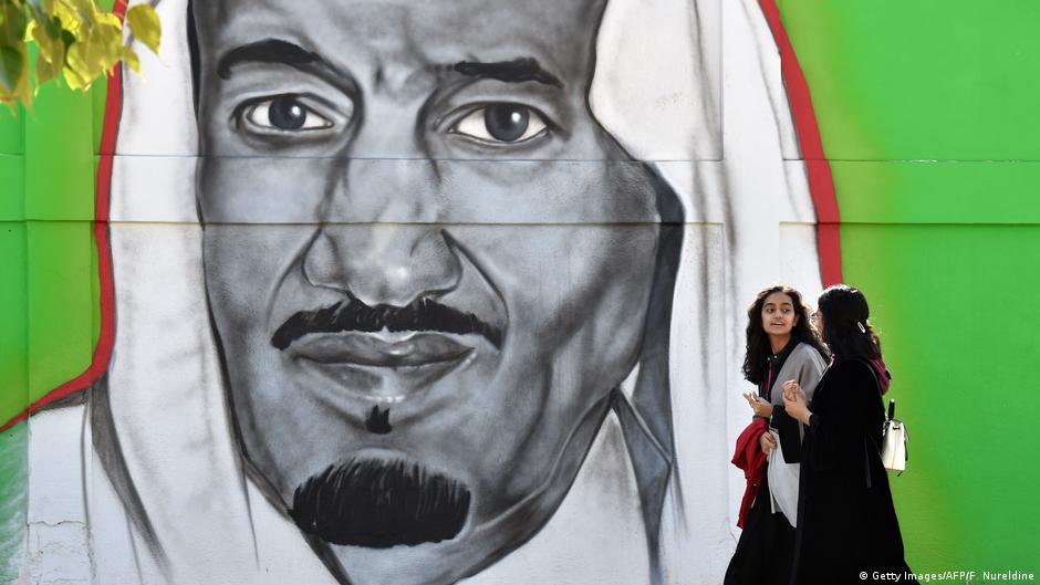 Two Saudi women in front of a poster of King Salman (photo: Getty Images/AFP/F.Nureldine)