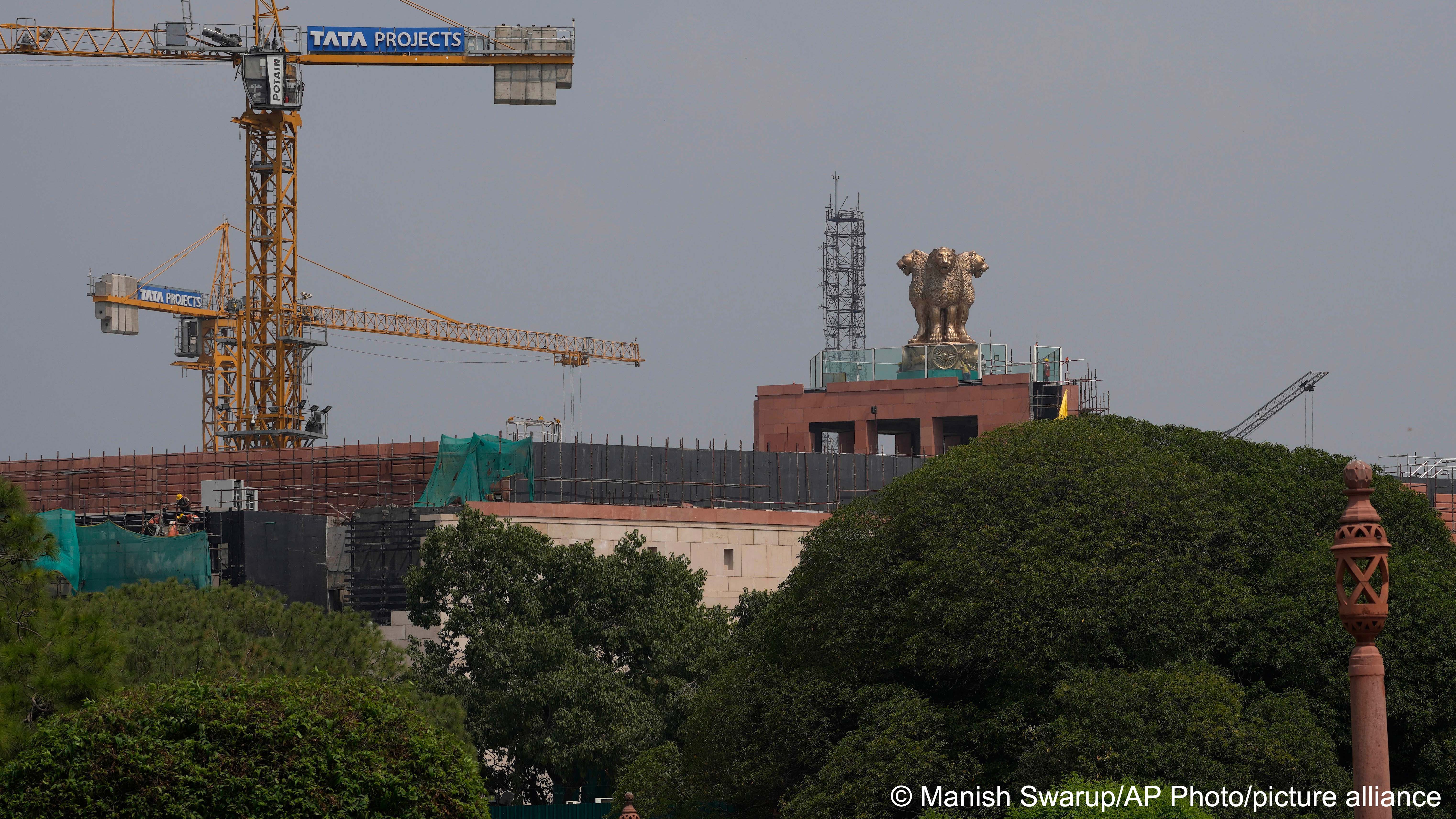 India's national emblem is seen on the roof of country's new parliament building under construction in New Delhi, India, 11 September 2022 (photo: AP Photo/Manish Swarup)
