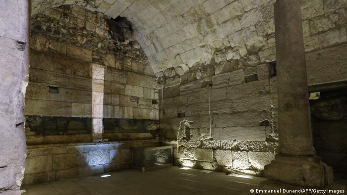 A view of a 2,000-year-old banquet hall in Jerusalem, with stone walls and a column.