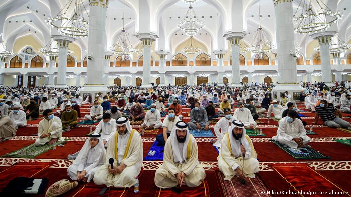 Men sit for morning prayer on the floor of the Imam Abdul Wahhab Mosque in Doha, Qatar