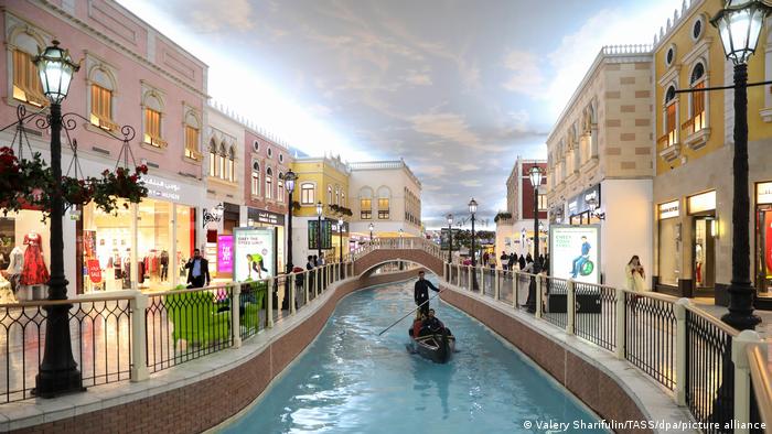 A gondola glides down an artificial canal in Villaggio Mall in Doha