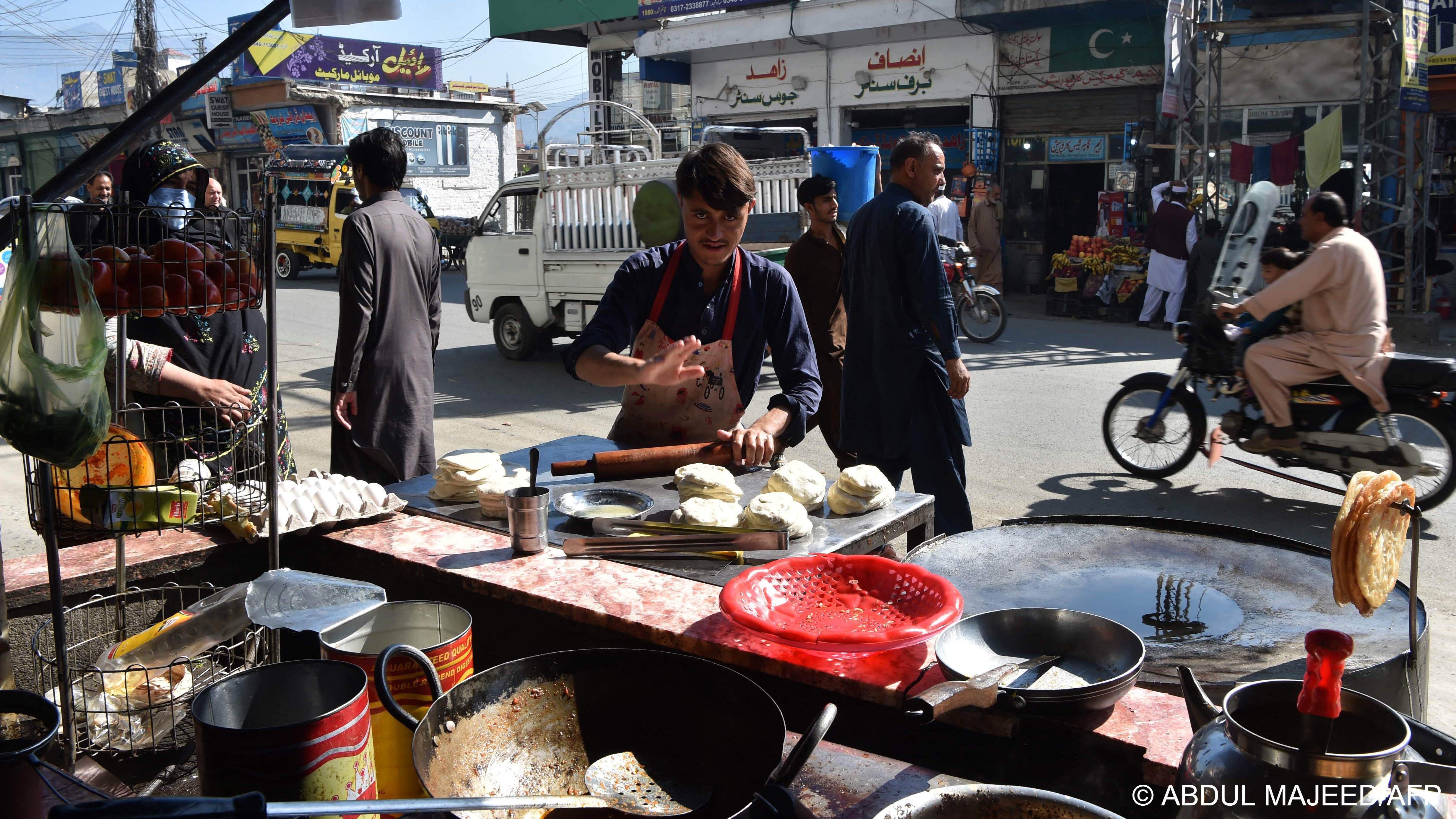 In this picture taken on 25 October 2022, a man prepares bread at a food stall in a market area of Mingora, in the Swat District of Khyber Pakhtunkhwa (photo: Abdul MAJEED / AFP)