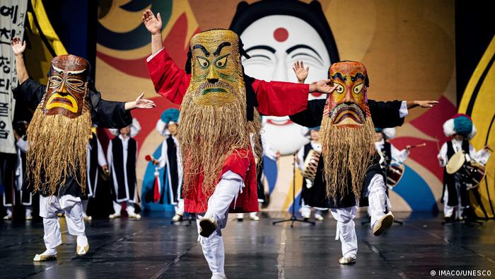 Dancers perform the mask dance Talchum, wearing huge masks with long beards