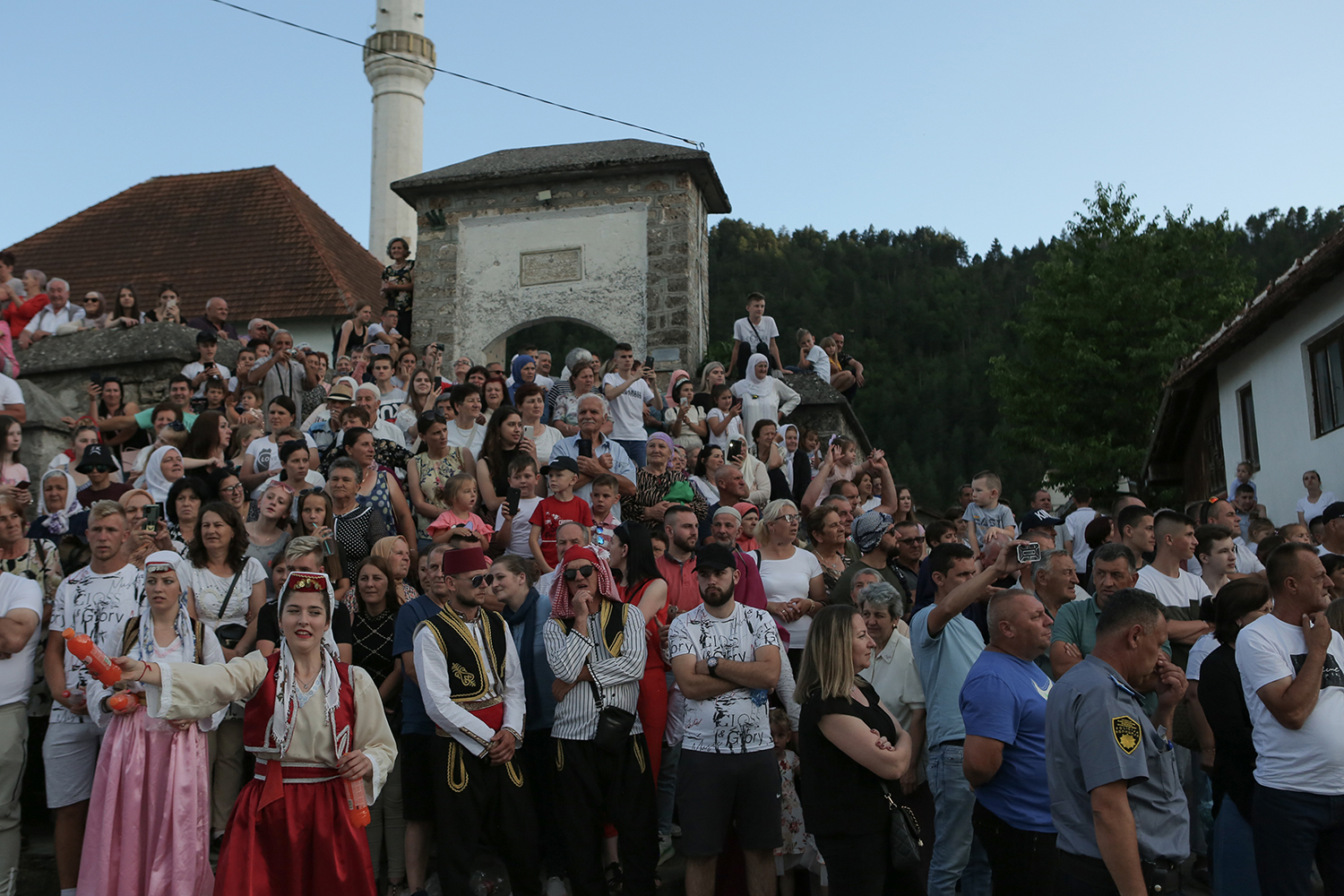 People, some dressed in colourful costumes, gather on the roadside to watch the procession (photo: Konstantin Novakovic)
