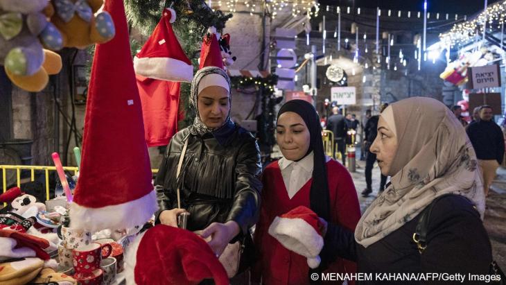 Muslim women shopping at a Christmas market in Jerusalem's Old Quarter, 15 December 2022 (photo: Menahem Kahana/AFP/Getty Images)