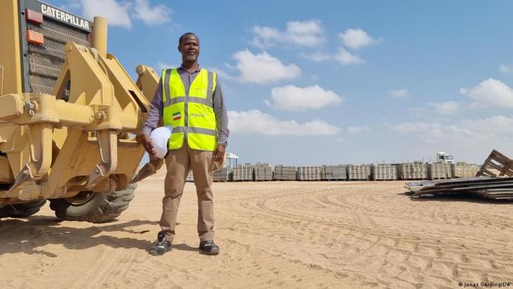 Joseph Oguta standing beside a truck on the site of the Berbera Economic Zone (photo: Jonas Gerding/DW)
