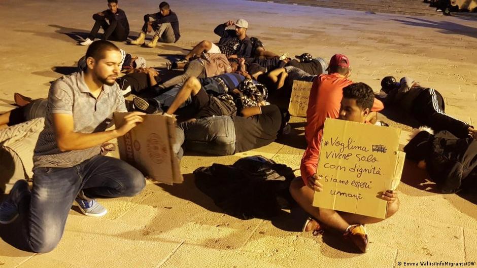 A group of Tunisians stage a sit-in outside a church, asking to remain in Italy, Lampedusa, 19 September 2019 (photo: Emma Wallis/infomigrants/DW)