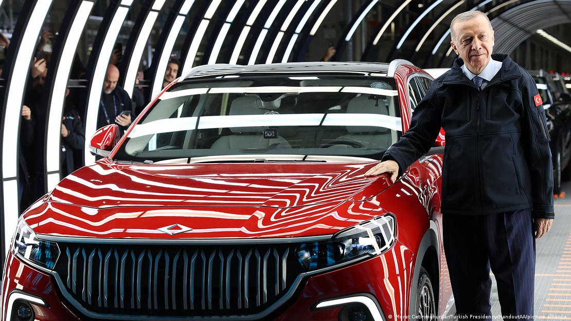 Turkish President Recep Tayyip Erdoğan stands next to a TOGG C-SUV, Bursa, Turkey, 29 October 2022 (photo: Murat Cetinmuhurdar/Turkish Presidency/HandoutAA/picture alliance)