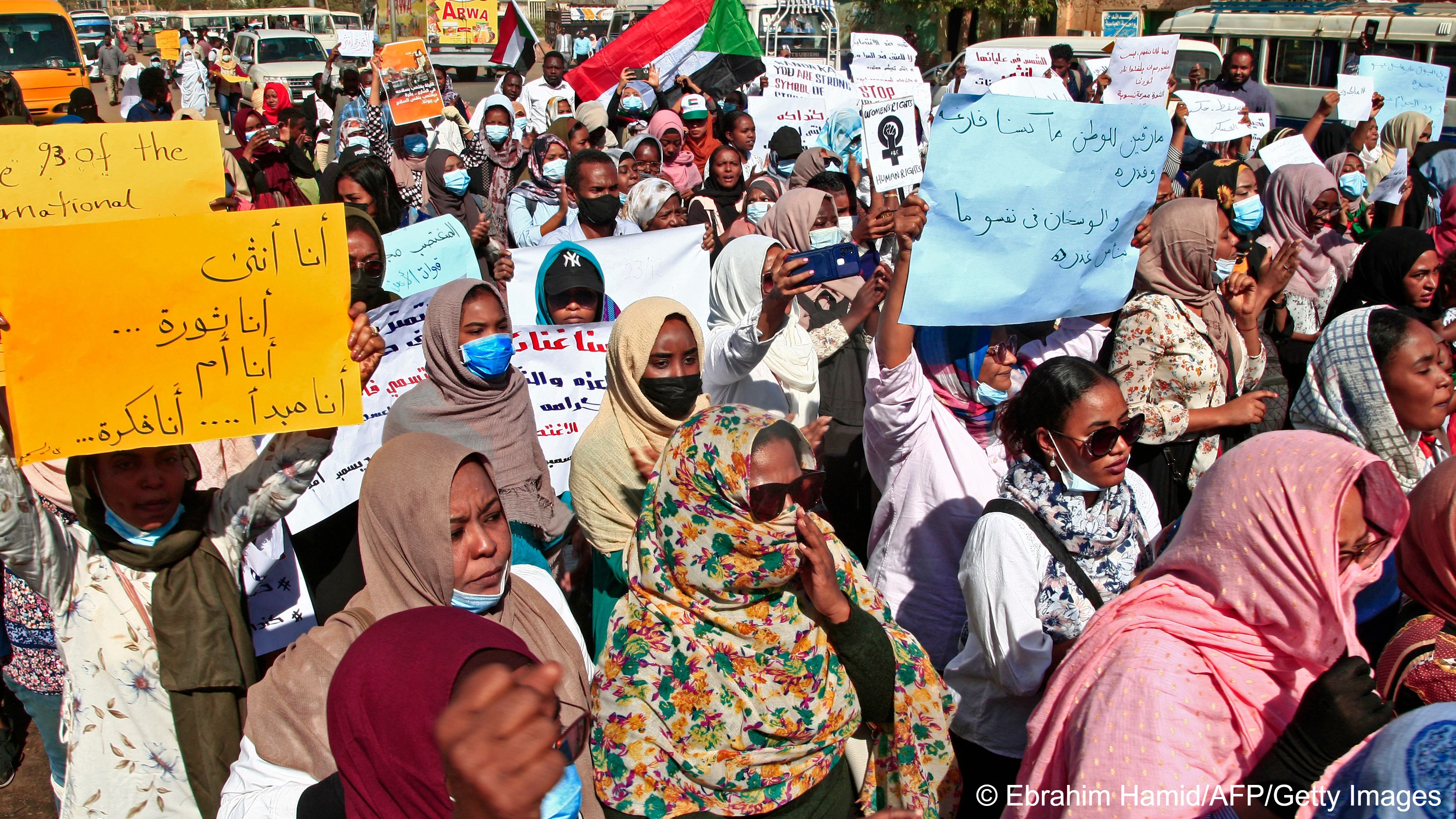 Sudanese women take part in a protest decrying sexual attacks, after the UN  said at least 13 women and girls were raped in the recent mass protests against the army, in Omdurman on 23 December 2021 (image: by Ebrahim HAMID/AFP)